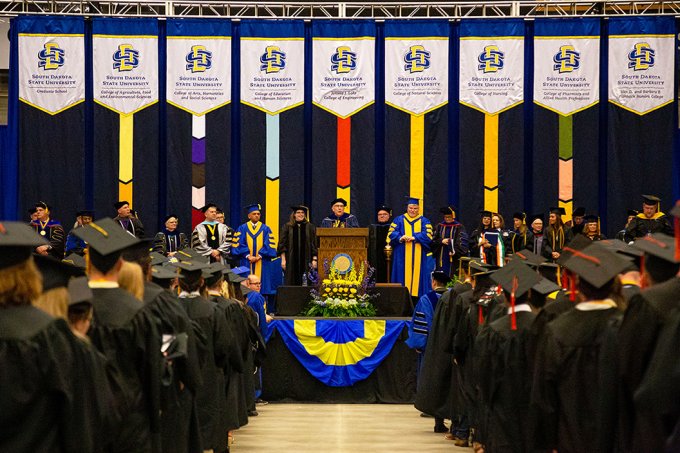 One of the 2023 South Dakota State University commencement ceremonies at the Dacotah Bank Center in Brookings is show, with SDSU President Barry Dunn addressing graduates.
