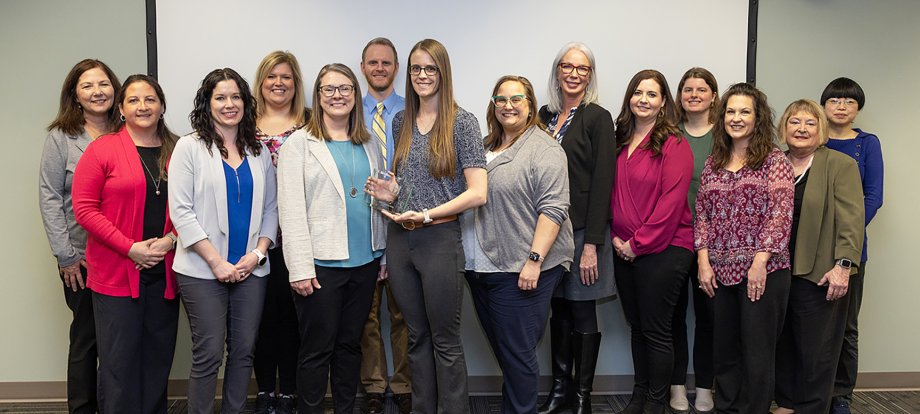 Staff of the Population Health Evaluation Center at South Dakota State University gather with South Dakota Department of Health representatives after the center was named the department's 2023 outstanding Partner in Health for the work the center does to support the department.