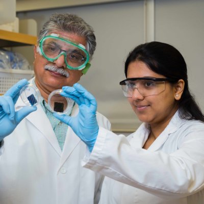 Sanjeev at the lab with a student