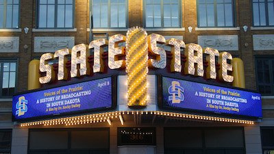 State theater with SDSU branding on digital display. 
