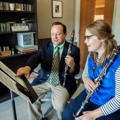 A teacher and student playing clarinet