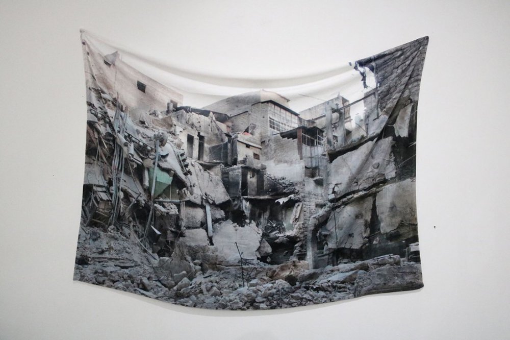 Essma Imady, "Receiving Blanket" (plush blanket, image of bombed home in Aleppo)